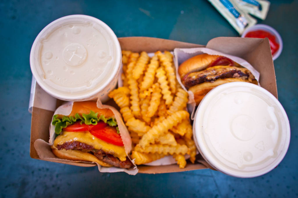 A vibrant shot of Shake Shack's iconic ShackBurger alongside their crinkle-cut fries. — burger chains Las Vegas