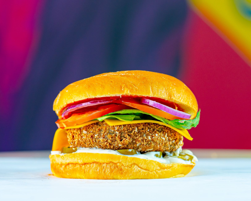 A vibrant vegan burger, stacked high with fresh vegetables and plant-based patties. — best burgers in Las Vegas