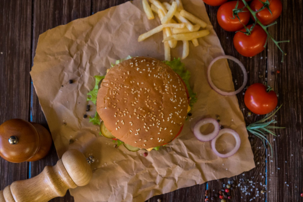 An artisan burger with gourmet toppings on a rustic wooden table. — juicy burgers Las Vegas