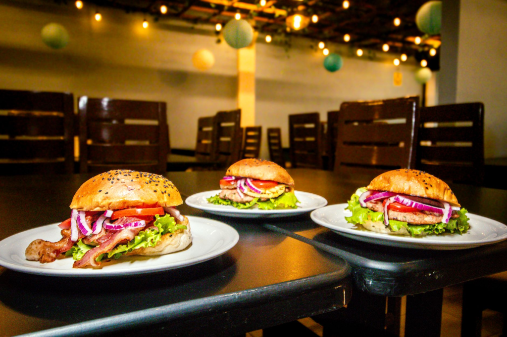 An inviting restaurant interior known for its delicious vegan burgers, showcasing the dining atmosphere. — plant-based b…