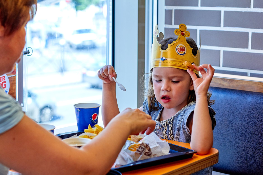 Happy children dining on burgers and fries in a family-oriented setting. — family burgers las vegas