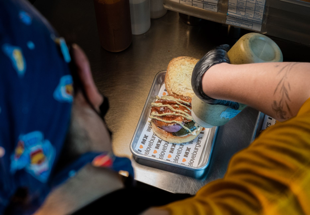 Participants in a burger competition showcasing their creations. — burger festivals Las Vegas