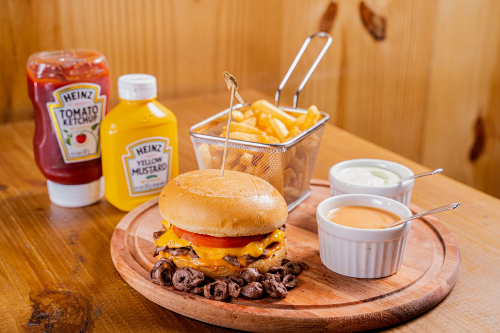 Smashburger with a side of crispy onion rings, highlighting quick meal options. — burgers near las vegas airport