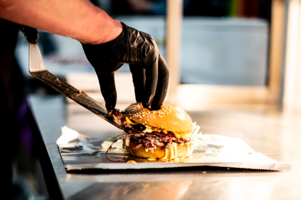 A Las Vegas chef preparing a gourmet burger with trendy toppings in a vibrant kitchen. — best burger toppings