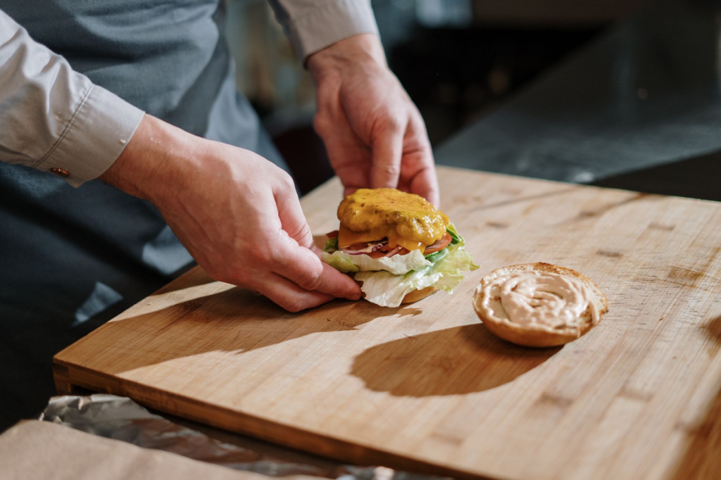 A chef preparing a burger in a bustling kitchen setting, emphasizing quality ingredients. — best burger ranking criteria