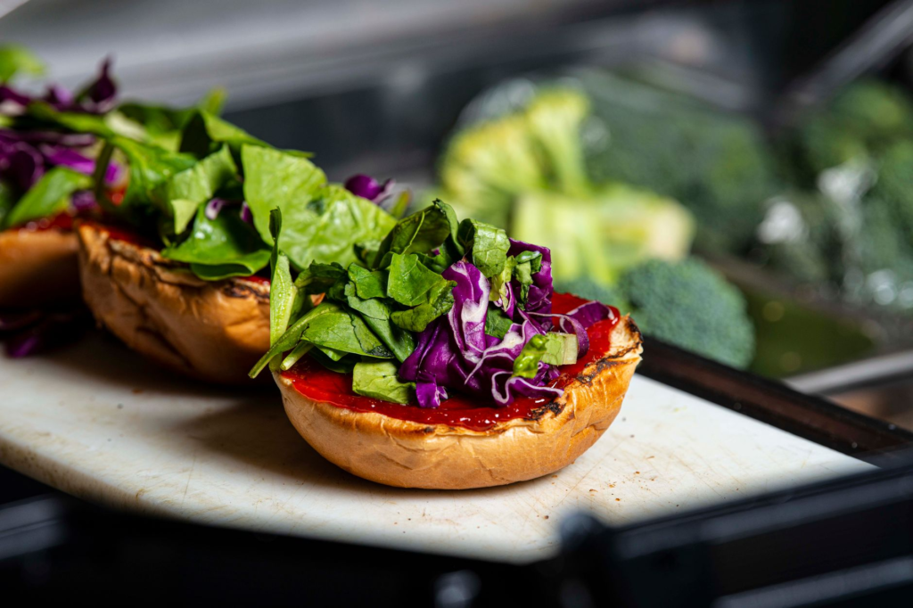 A close-up of a signature vegan burger showcasing fresh ingredients. — vegan burgers Las Vegas