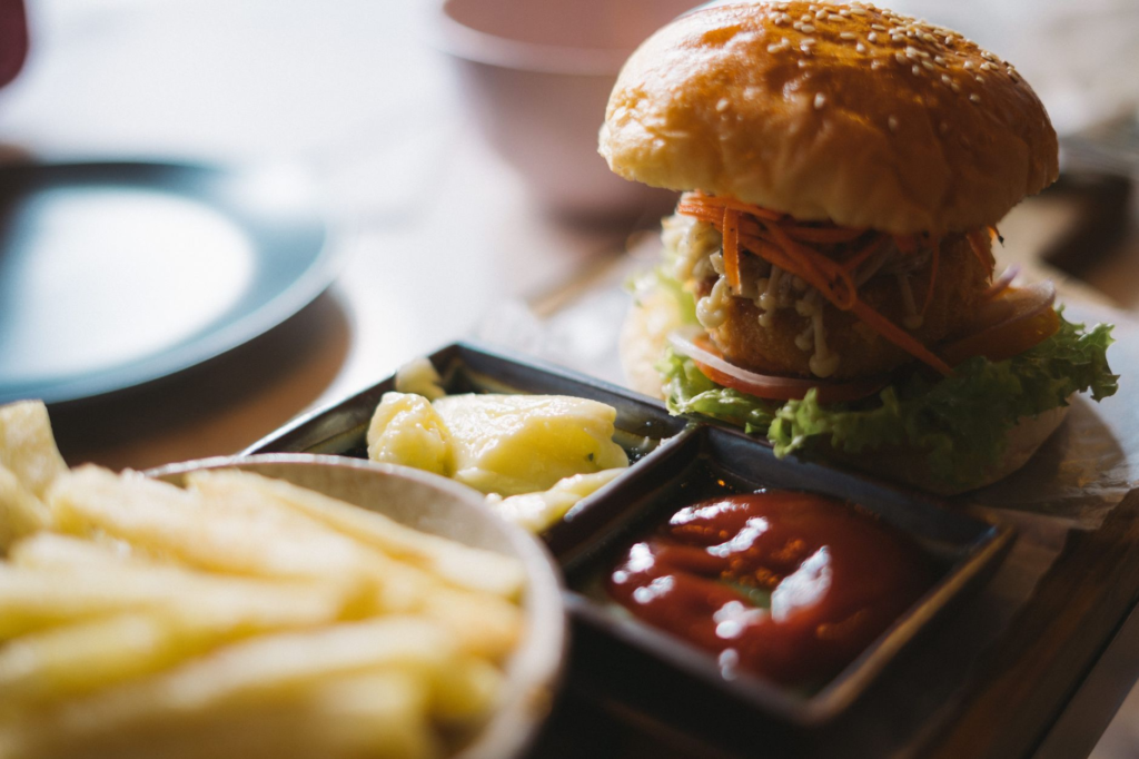 A colorful platter of sides and sauces served with a vegan burger — vegan burgers Las Vegas