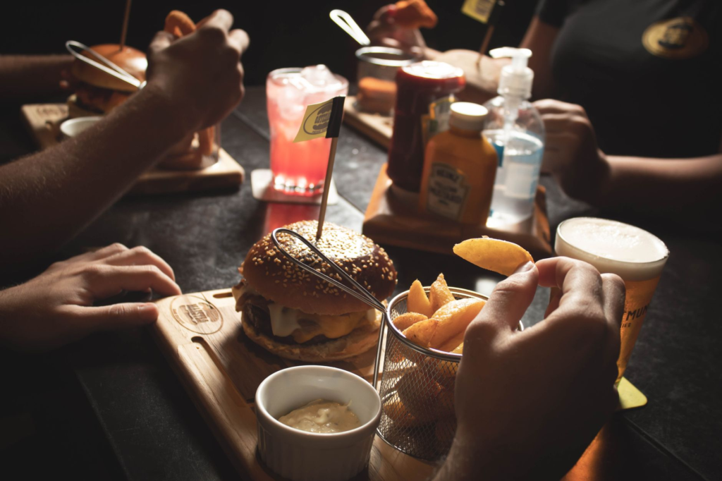 A colorful platter of various burgers with unique toppings, perfect for sharing with friends during a night out. — late …