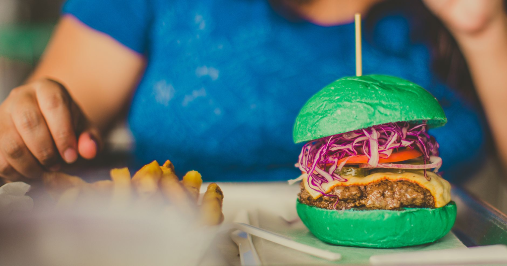A colorful platter showcasing various gourmet burger toppings, including fresh vegetables and unique sauces. — best burg…