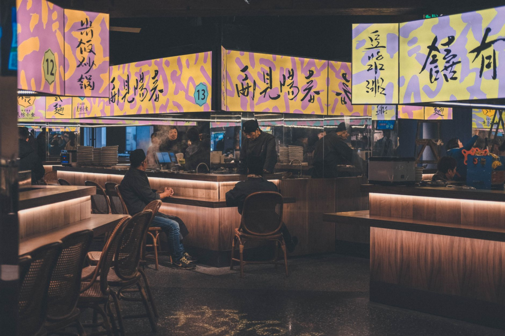 A cozy interior shot of a vegan restaurant in Las Vegas bustling with diners enjoying their meals. — vegan burgers Las V…