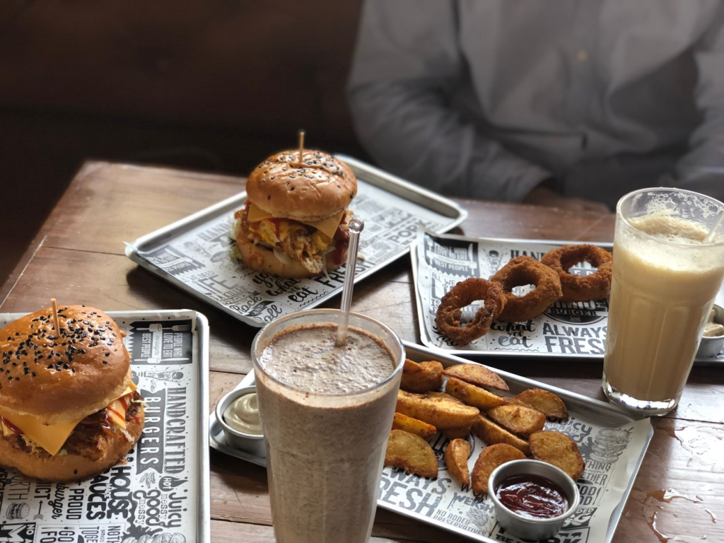 A cozy setting at Holsteins Shakes and Buns featuring a couple enjoying their burgers. — romantic restaurants las vegas