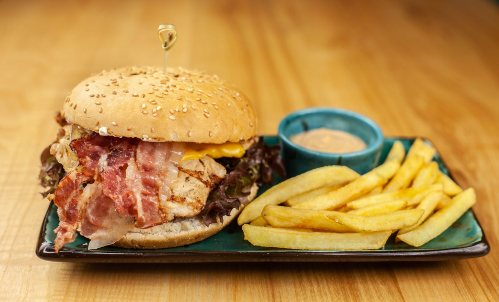 A delicious cheeseburger with crispy fries on a wooden table — burger pairings Las Vegas