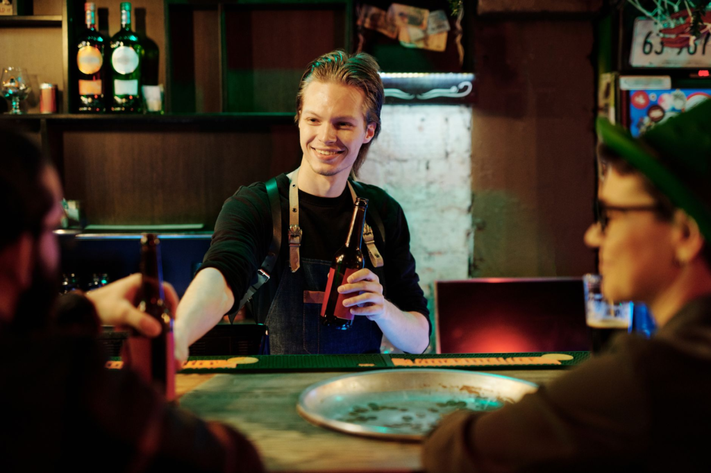 A friendly bartender serving happy hour burgers with a smile, emphasizing customer service and atmosphere. — burger deal…
