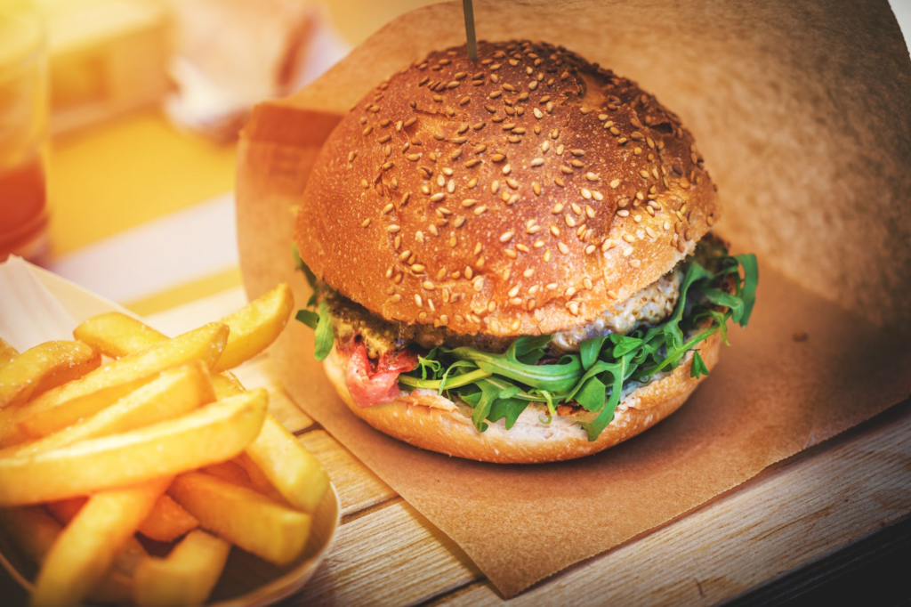 A gourmet truffle burger garnished with arugula and truffle oil. — best burgers in Las Vegas