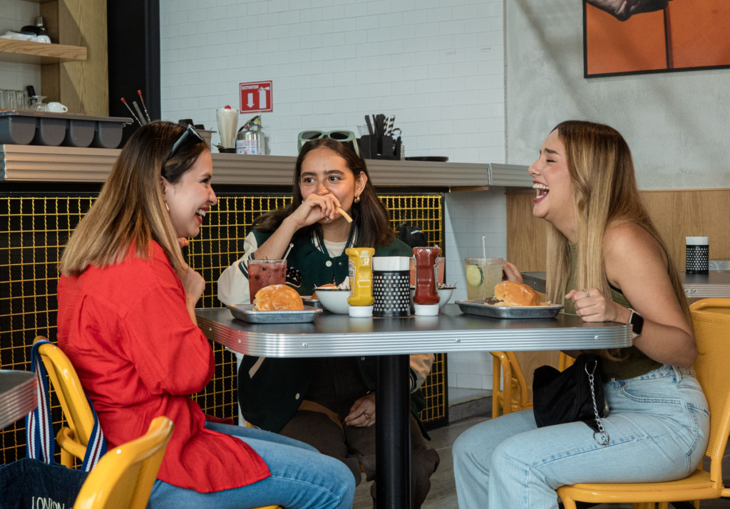 A group of friends enjoying a spicy burger challenge at a popular Las Vegas restaurant. — spicy burgers Las Vegas
