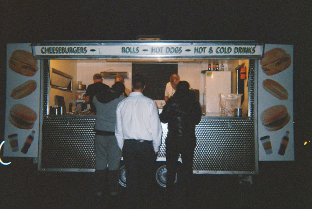 A group of friends enjoying burgers and drinks at a late-night diner — late night burgers Las Vegas