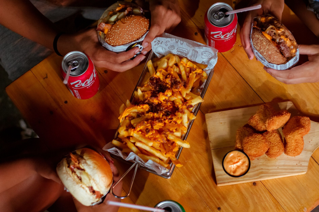 A group of friends enjoying burgers at a Las Vegas eatery, capturing the social aspect of dining. — in n out vs vegas bu…