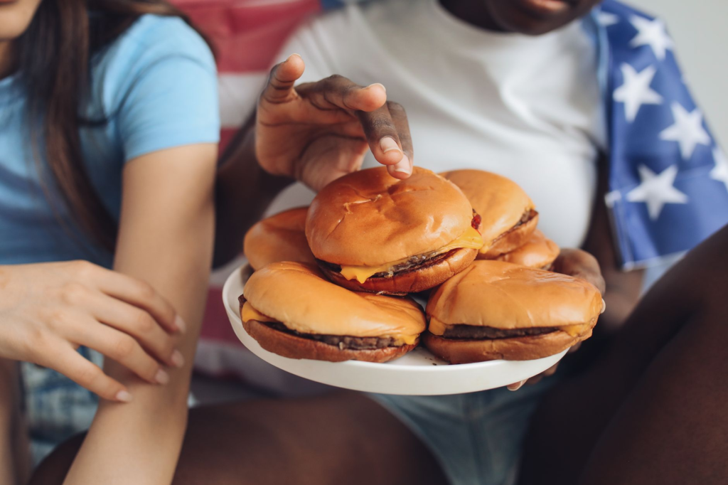A group of friends sampling different burgers at a festival, highlighting the social aspect of burger festivals Las Vegas.