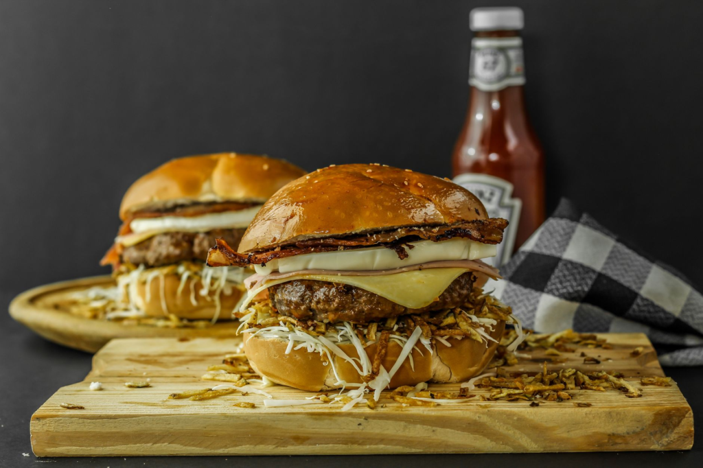 A mouth-watering gourmet burger with toppings, showcasing a special summer deal. — burger deals Las Vegas