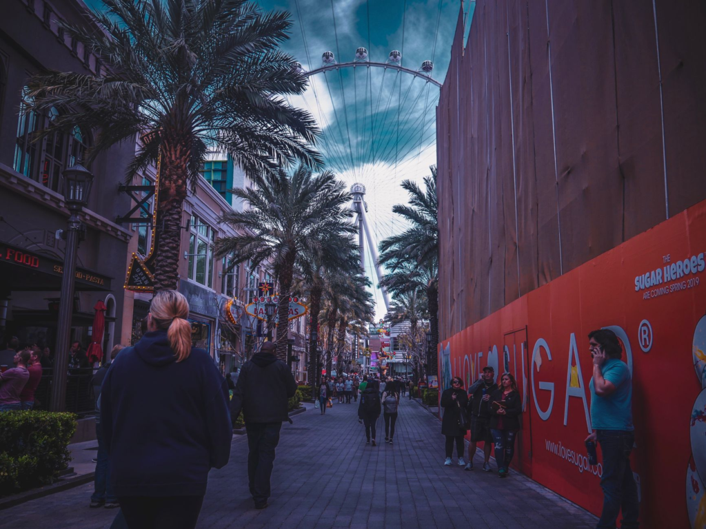 A vibrant image of a burger restaurant's exterior on the Las Vegas Strip, bustling with customers. — juiciest burgers La…