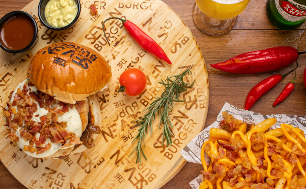 A vibrant shot of a spicy burger with a side of fiery hot wings and dipping sauce. — spicy burgers Las Vegas