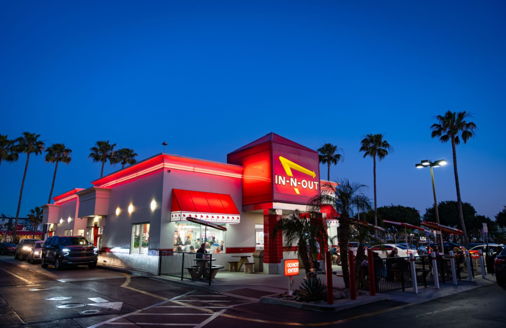 A vibrant shot of the In-N-Out Burger sign with a line of eager customers. — best burgers in Las Vegas