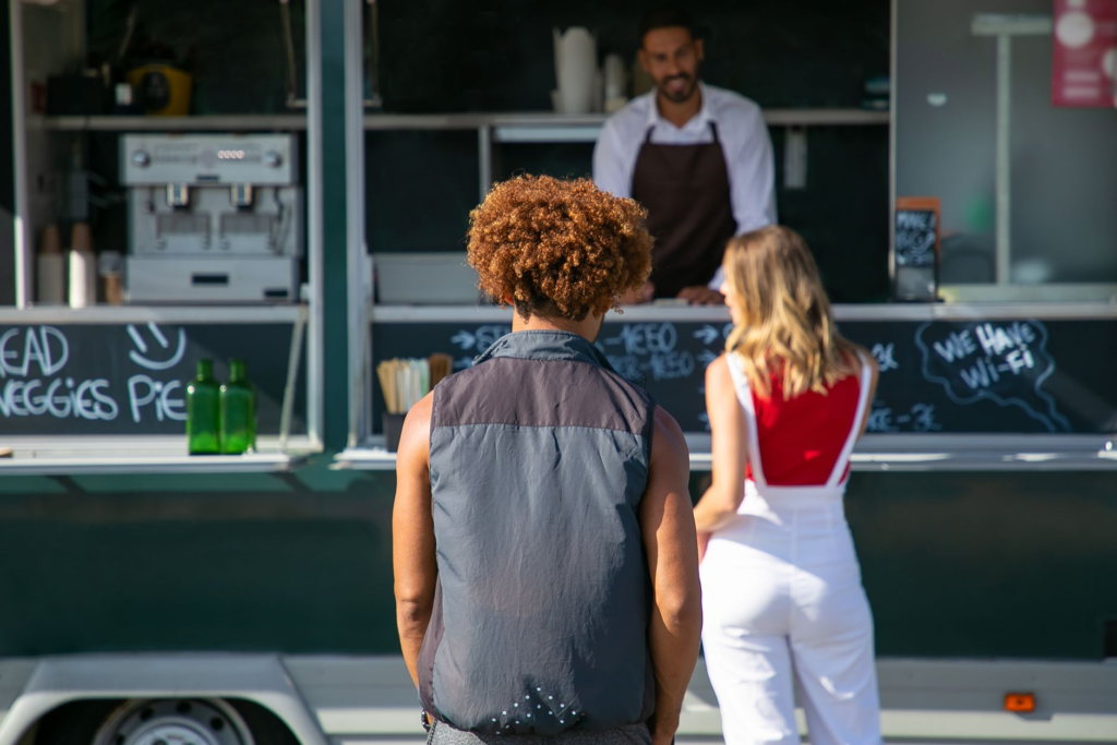 An outdoor dining scene at Plant Power Fast Food with customers enjoying their meals. — best vegetarian burgers Las Vegas