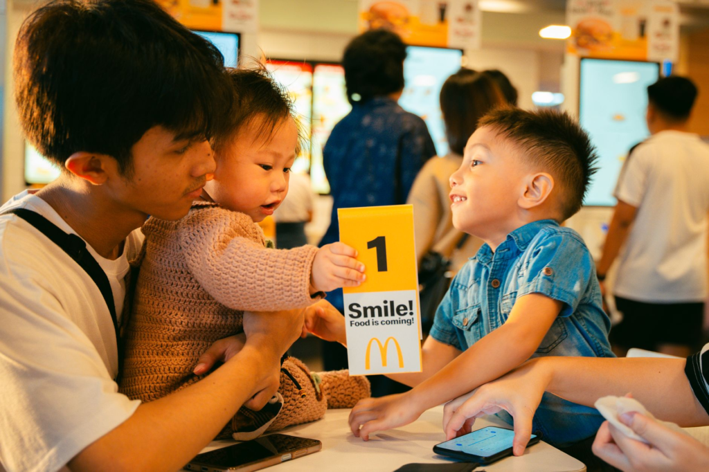 Children smiling while choosing items from a kids menu — family-friendly burgers Las Vegas