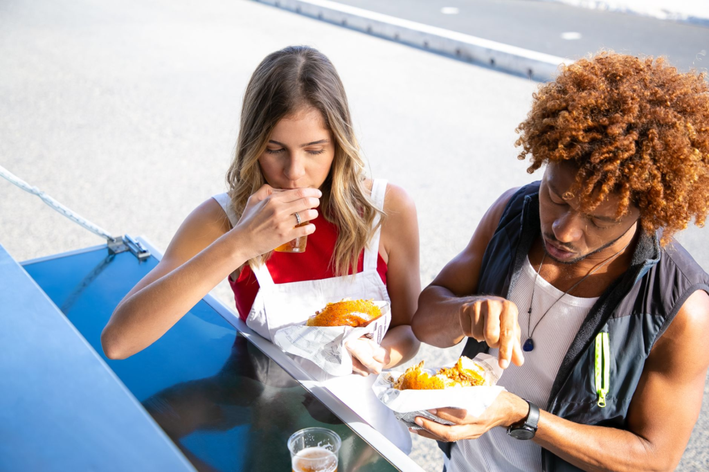 A group of friends enjoying burgers from different food trucks. — burger food trucks Las Vegas
