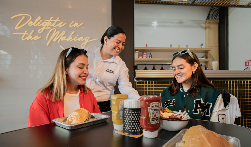 A vibrant family enjoying burgers at a popular Las Vegas restaurant, showcasing a friendly atmosphere. — family-friendly…